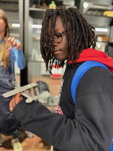 Student2 holds example of medal fabrication of model plane